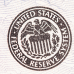 Seal of the United States Federal Reserve System, featuring an eagle atop a shield, surrounded by laurel leaves.