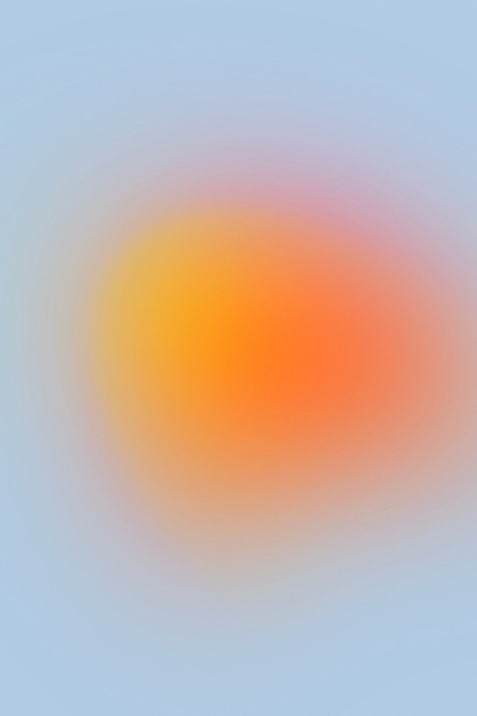 Soft gradient background with orange, yellow, and pink hues blending into a light blue backdrop.
