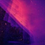 Purple and pink abstract background with scattered particles and a dark silhouette of a building partially reflected.
