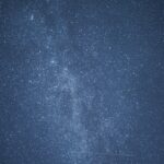 A dark blue sky filled with numerous bright stars, creating a dense, sparkling effect across the entire image.