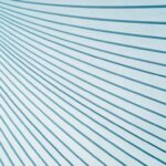 Diagonal blue and white lines create a geometric pattern on a light background, forming a dynamic visual effect.