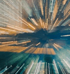 Colorful blurred lights create a dynamic, zooming effect, resembling a vibrant cityscape at night.