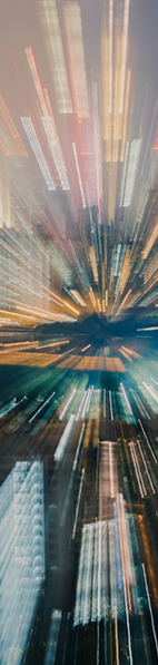 Colorful blurred lights create a dynamic, zooming effect, resembling a vibrant cityscape at night.